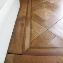 A close up of the inlaid edging of the completed renovated floor.